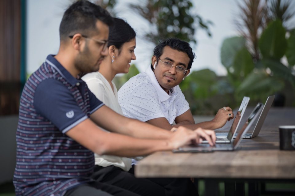 A startup team working together at laptops